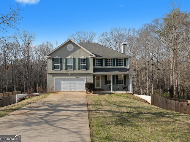 view of front of property featuring covered porch, a front yard, and a garage