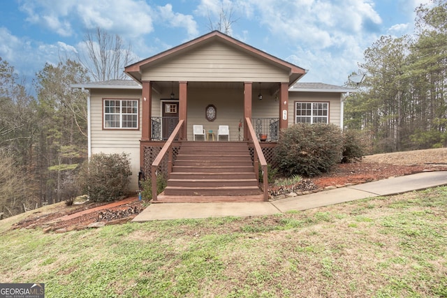 bungalow-style home featuring a porch and a front lawn