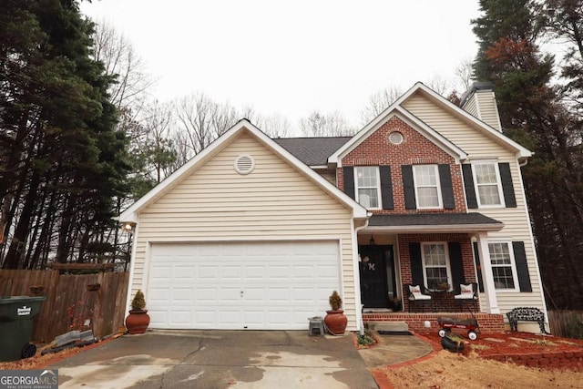 front of property featuring a garage and covered porch