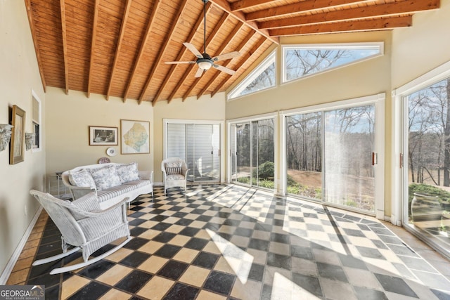 unfurnished sunroom with vaulted ceiling with beams, wooden ceiling, plenty of natural light, and a ceiling fan