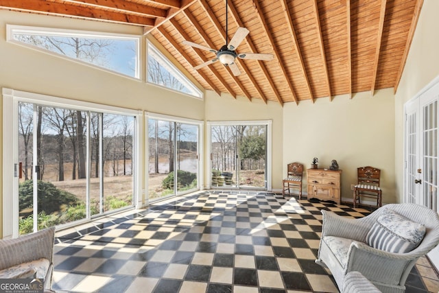 unfurnished sunroom with a ceiling fan, wooden ceiling, and lofted ceiling with beams