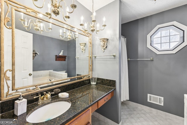 full bathroom featuring a garden tub, baseboards, visible vents, and vanity