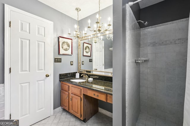 full bath featuring a tile shower and vanity