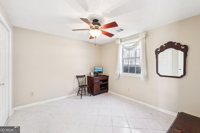 office area with ceiling fan, visible vents, and baseboards