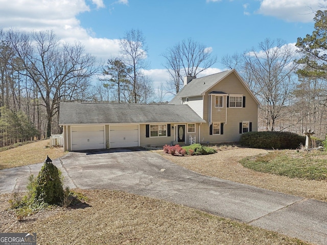 traditional-style home with a garage, aphalt driveway, and a chimney