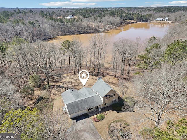 drone / aerial view with a water view and a forest view