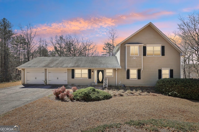 traditional home with driveway and an attached garage