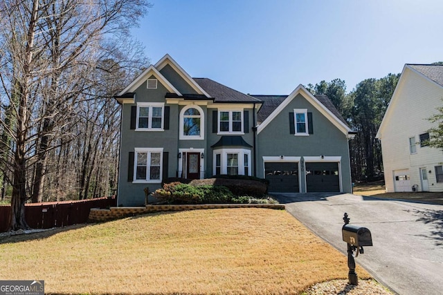 view of front of house featuring a garage and a front yard