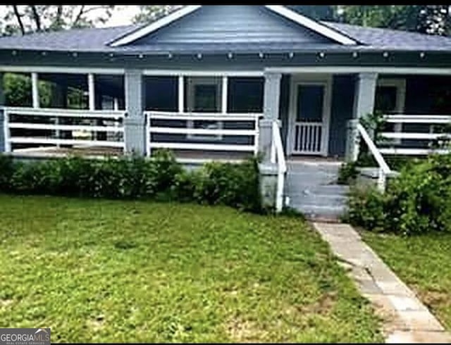 bungalow-style house with a front yard