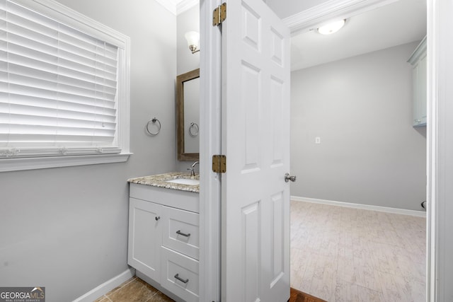 bathroom featuring baseboards and vanity