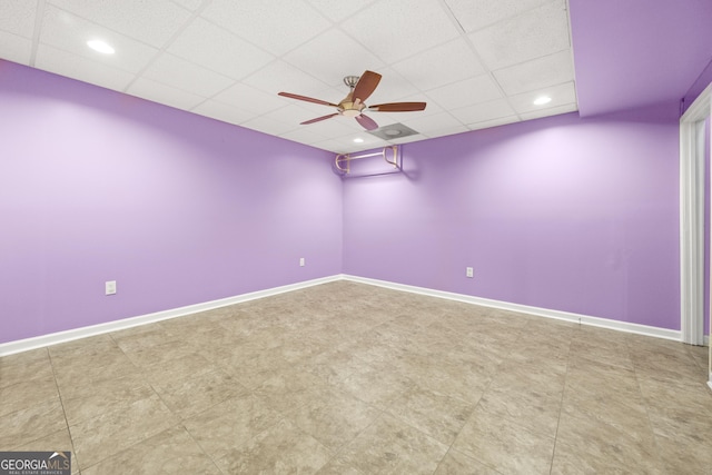 spare room featuring ceiling fan, baseboards, a drop ceiling, and recessed lighting