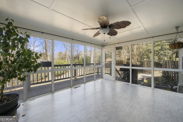 unfurnished sunroom with ceiling fan and visible vents