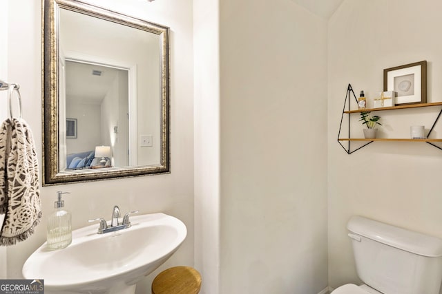 bathroom with toilet and a sink