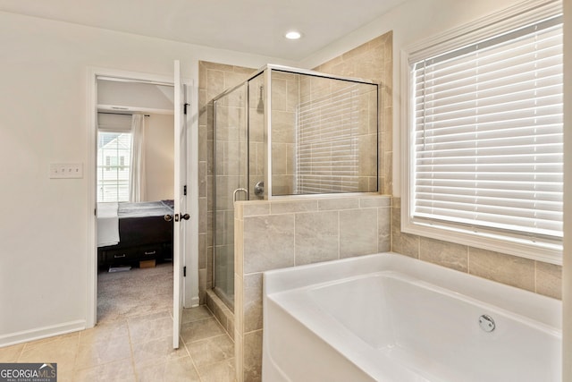 bathroom with tile patterned flooring, recessed lighting, a bath, a stall shower, and ensuite bath