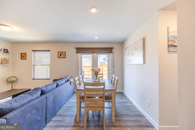 dining area featuring dark wood-type flooring and a wealth of natural light