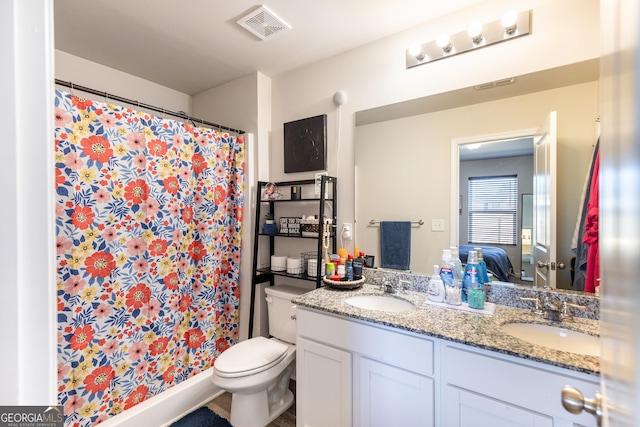 bathroom featuring a shower with curtain, vanity, and toilet