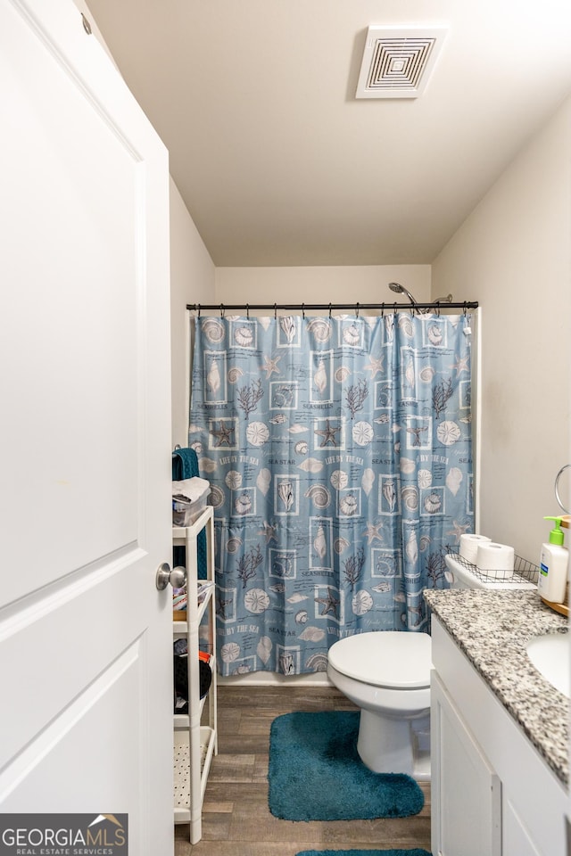 bathroom with vanity, hardwood / wood-style flooring, toilet, and a shower with shower curtain