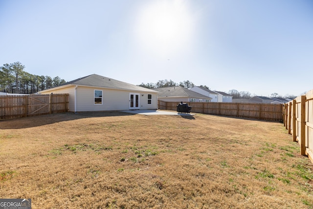 view of yard with a patio area and french doors