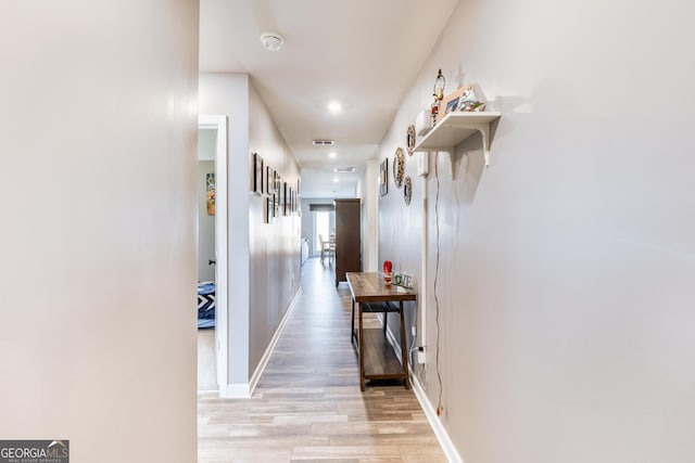 corridor with light hardwood / wood-style floors