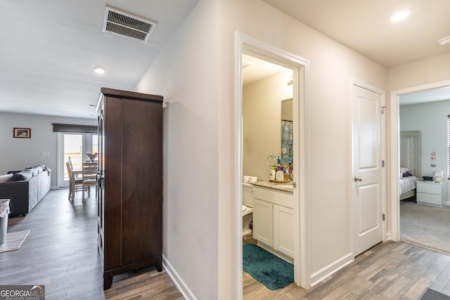 corridor with light hardwood / wood-style flooring