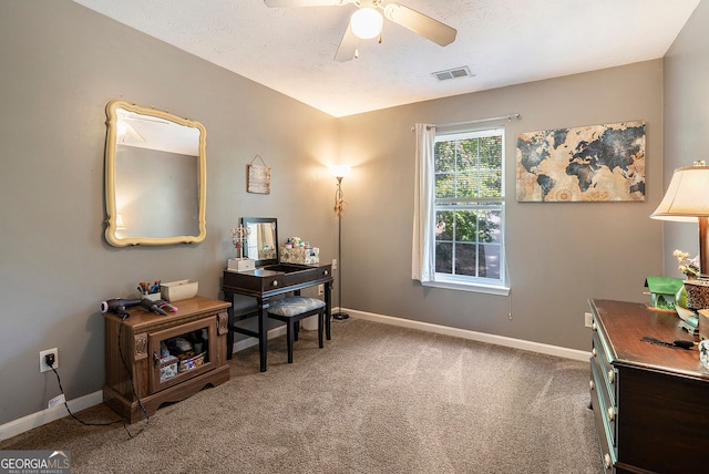 carpeted office featuring a ceiling fan, visible vents, and baseboards