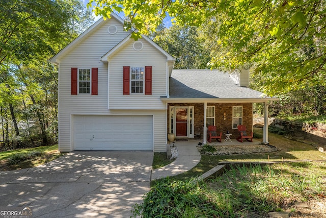 tri-level home with an attached garage, a porch, roof with shingles, a chimney, and driveway