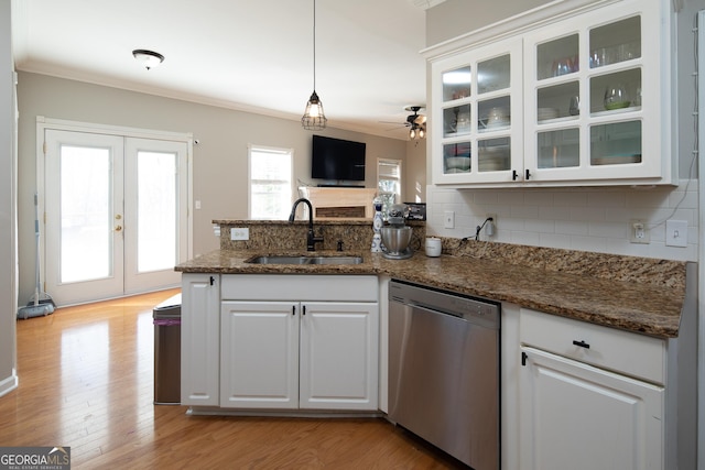 kitchen featuring white cabinetry, stainless steel dishwasher, crown molding, and sink