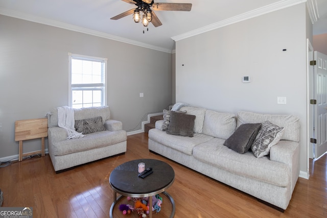 living room with ornamental molding, hardwood / wood-style floors, and ceiling fan