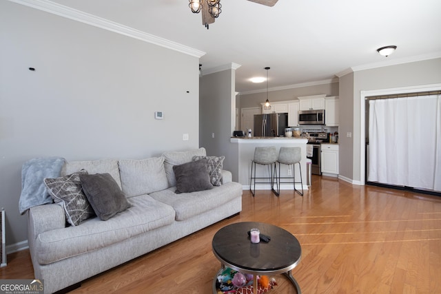 living room with crown molding and light hardwood / wood-style flooring