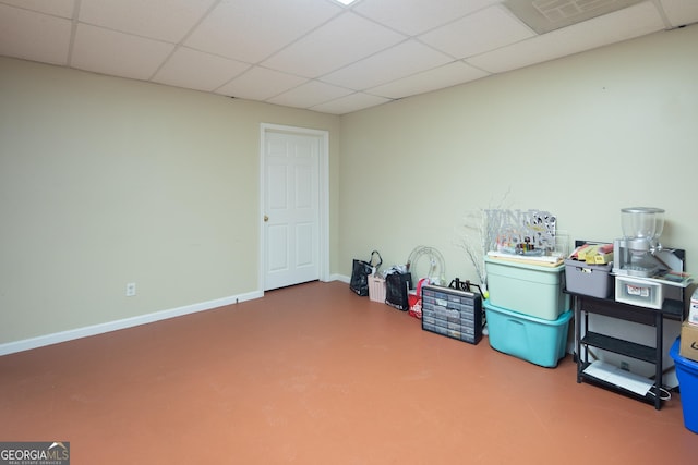 interior space with a drop ceiling and concrete floors