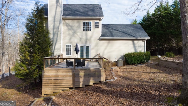 rear view of house with central AC and a deck