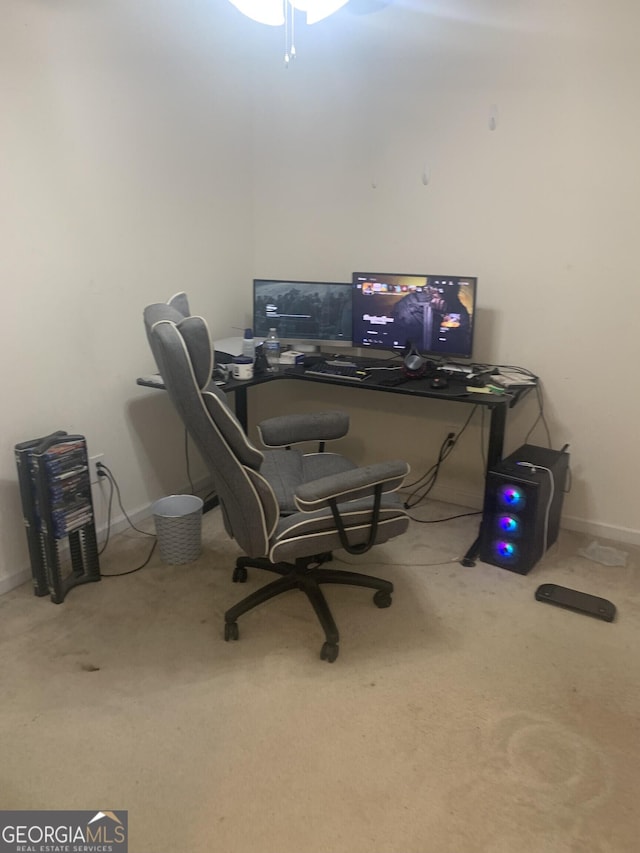 carpeted home office featuring baseboards