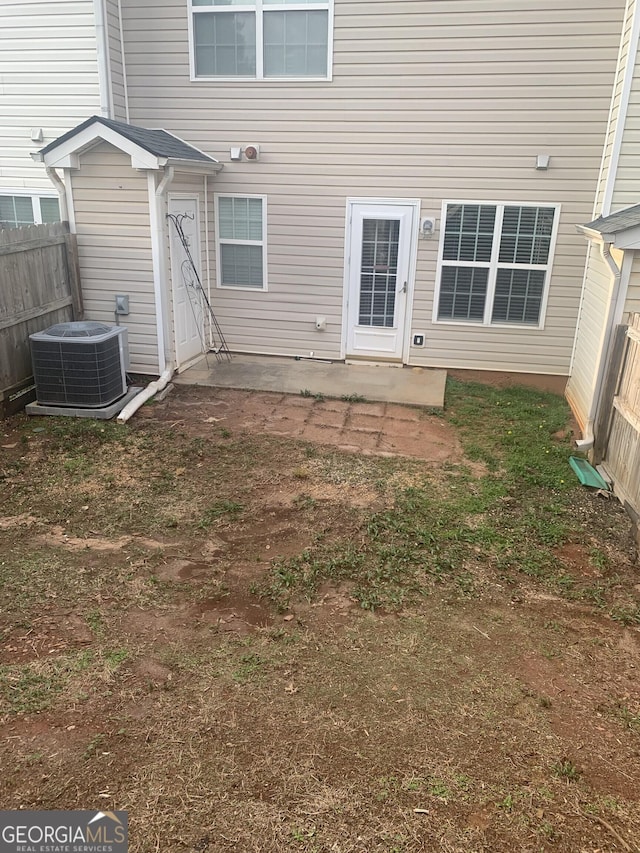 back of house with central AC, a patio, and fence