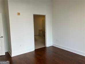 empty room with dark hardwood / wood-style floors
