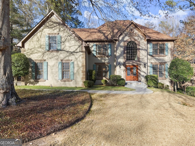 view of front facade featuring a front lawn and french doors