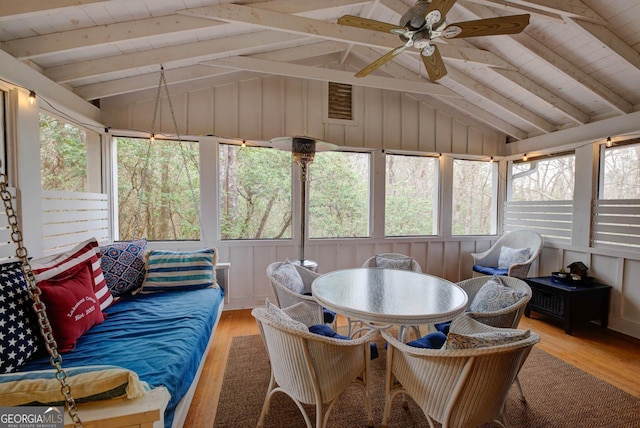 sunroom with vaulted ceiling with beams, wood ceiling, and ceiling fan