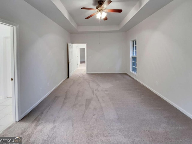 interior space with a tray ceiling and ceiling fan