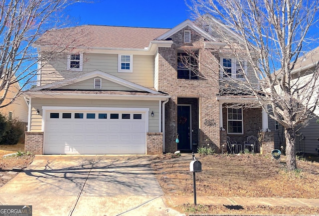 traditional-style house with brick siding, driveway, and a garage