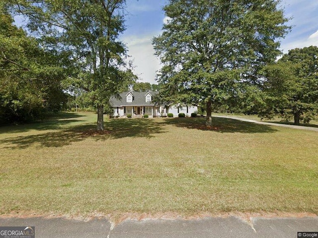 cape cod house with a front yard