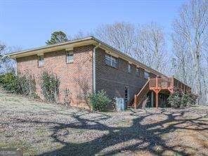 view of side of property with stairs and a deck