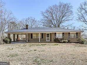 view of front of home with an attached carport and a chimney