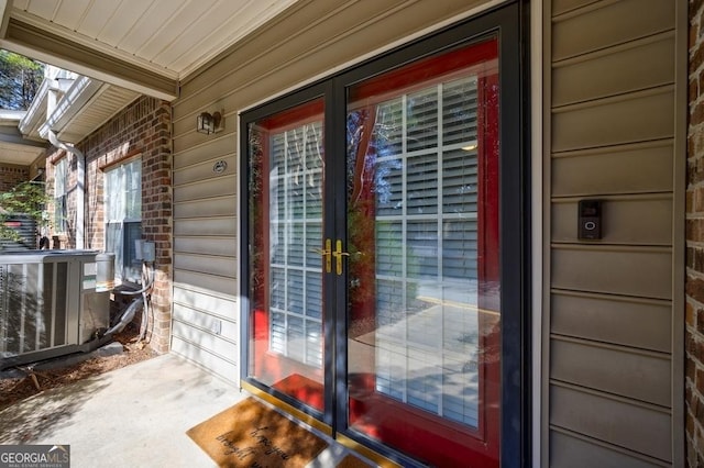 view of exterior entry featuring central AC unit