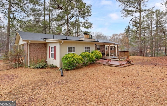 rear view of house featuring a deck