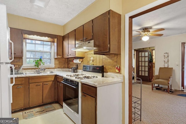 kitchen with tasteful backsplash, sink, white appliances, ceiling fan, and a textured ceiling