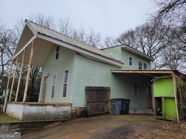 view of home's exterior with a carport