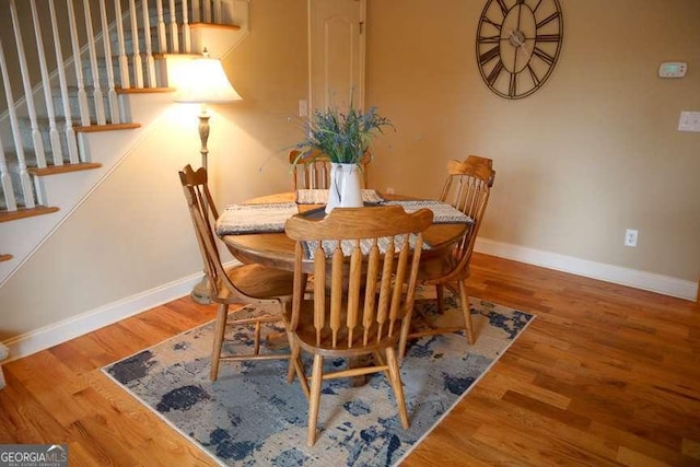 dining space with hardwood / wood-style flooring