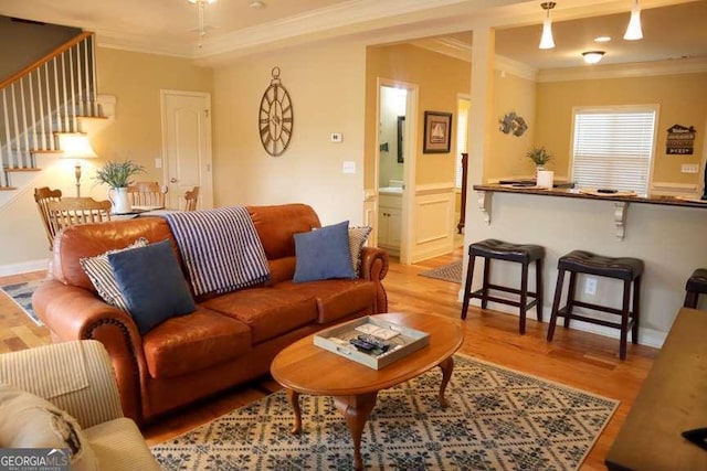 living room featuring crown molding and wood-type flooring