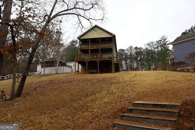 back of house featuring stairway