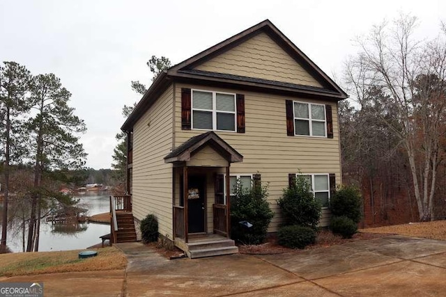 view of front of house with a water view