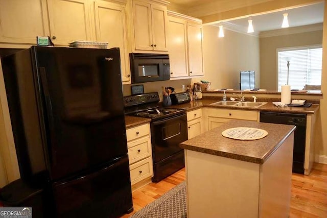 kitchen with a sink, black appliances, ornamental molding, and dark countertops